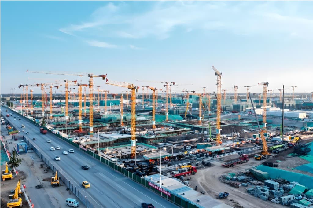 Large construction site with rows of tower cranes