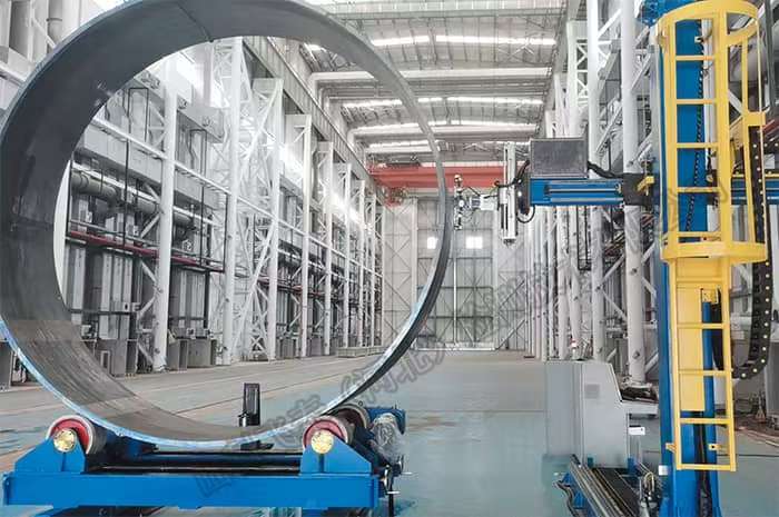 Large-diameter pipe section on rotators at an automated inspection gantry